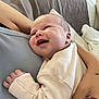 Emmy participe au concours pour gagner de l'argent avec cette photo : baby, smiling, infant, person, arm, hand, clothing, indoor, couch, blanket, happy, face, skin, newborn, comfort, holding, closeup, cute, soft, relaxation
