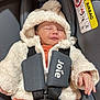 Emmy participe au concours pour gagner de l'argent avec cette photo : baby, infant, car_seat, harness, jacket, hood, sleeping, child, seatbelt, safety, orange_clothing, gray, red_button, warning_label, airbag, soft_texture, cute, peaceful, cozy, indoor