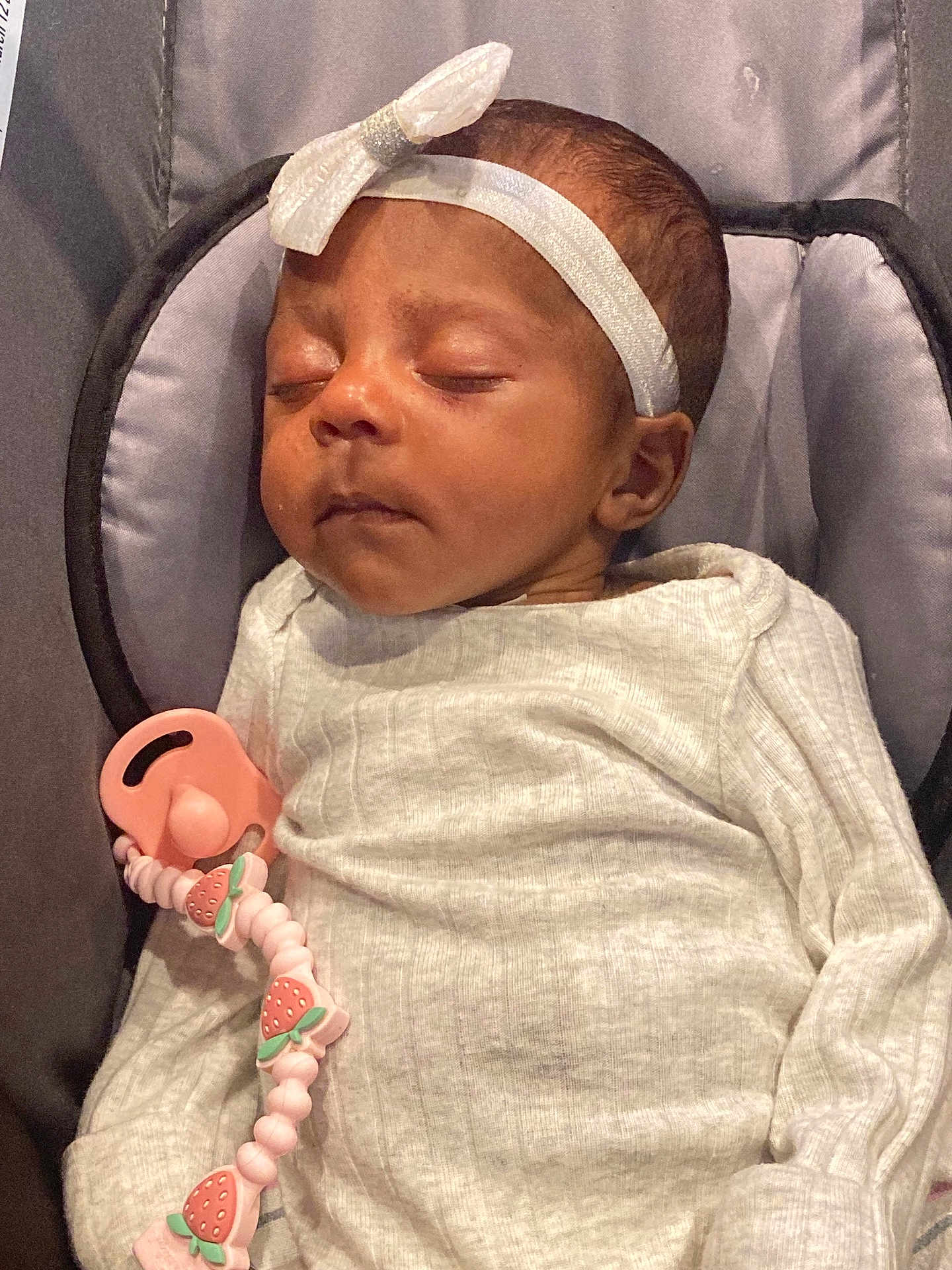 Raya joined the competition — help win amazing prizes! baby, sleeping, headband, bow, white_clothing, pacifier, strawberry, clip, infant, cute, cozy, padded_surface, gray_background, peaceful, child, newborn, resting, soft_texture, indoors, portrait