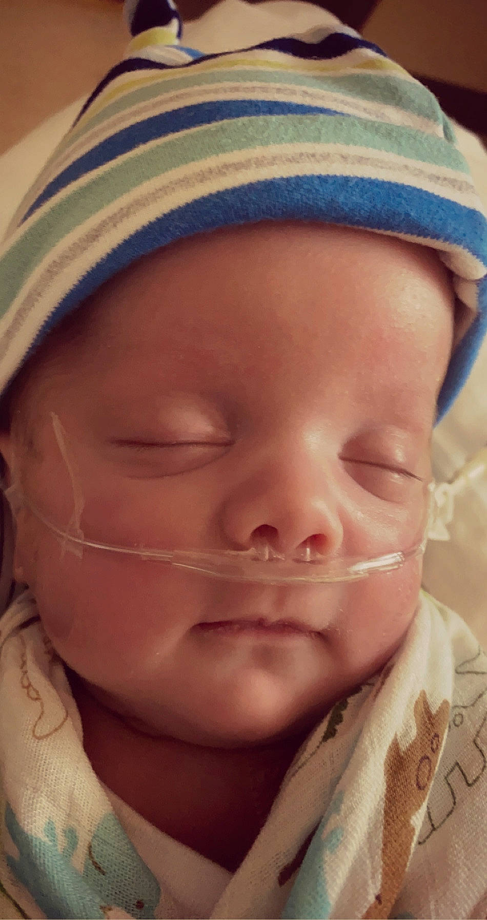 Emmett is registered to the contest to win money with this photo: baby, cheek, child, chin, close_up, eye, eyebrow, face, facial_expression, forehead, head, headgear, lip, mouth, nose, person, skin, smile, toddler