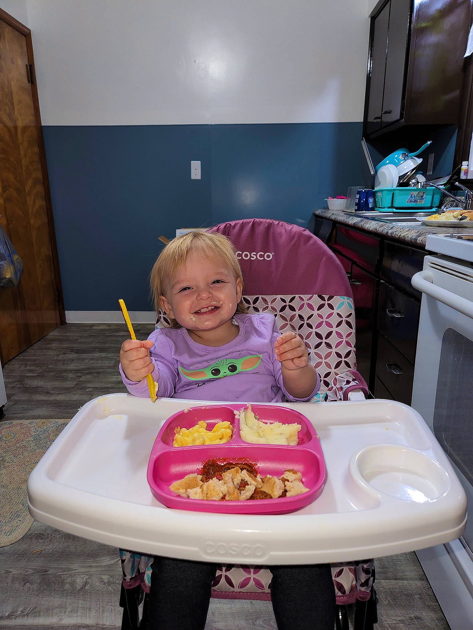 Kynzlee is registered to the contest to win money with this photo: baby, baby_toddler_clothing, cabinetry, chair, child, computer_keyboard, computer_monitor, cooking, food, happy, joy, magenta, peripheral, person, pink, product, sitting, smile, t_shirt, table