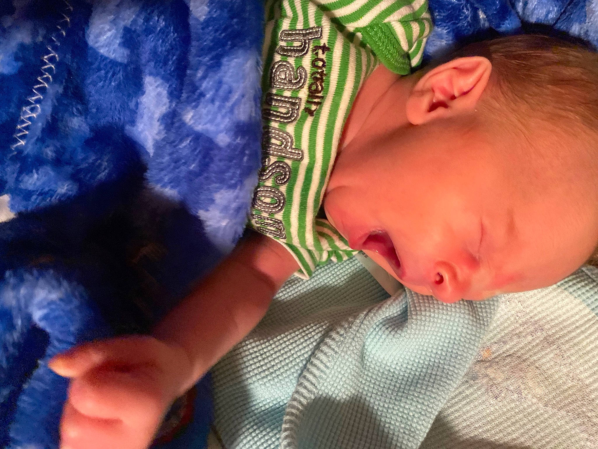 Raymond is registered to the contest to win money with this photo: baby, bedtime, blue, child, comfort, electric_blue, eyelash, finger, gesture, hair, hand, linens, nail, neck, nose, pattern, person, skin, sleeve, textile