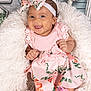 baby, child, smiling, pink_dress, floral_pattern, headband, bow, cushion, fluffy, indoors, decor, star, vintage, happy, portrait, cute, sitting, person, infant, footwear