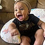 baby, infant, smiling, headband, jordan_clothing, couch, pillow, unicorn_pattern, happy, child, indoors, sitting, cute, skin, foot, hand, apparel, accessory, home, cheerful