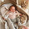 baby, baby_clothes, bassinet, blanket, clothing, comfort, cozy, cute, dried_flowers, face, head, indoor, infant, nursery, octopus_plush, portrait, resting, socks, soft_lighting, stuffed_toy