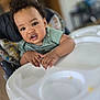 toddler, child, high_chair, curly_hair, indoor, tray, hands, expression, face, clothing, person, young_child, furniture, home, baby, seat, table, skin, portrait, cute