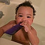 toddler, child, bath, bathtub, water, comb, curly_hair, skin, hand, face, earring, playing, cute, indoor, closeup, person, young_child, bath_time, wet, expression