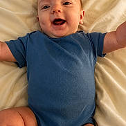 Mitchell joined the competition — help win amazing prizes! baby, infant, blue_onesie, smiling, happy, lying_down, blanket, soft_texture, arms_outstretched, cute, child, skin, head, legs, chubby, portrait, person, indoors, comfort, joy
