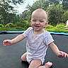 Miranda is registered to the contest to win money with this photo: baby, child, smiling, trampoline, outdoor, greenery, grass, trees, nature, playful, cute, infant, onesie, sunlight, candid, happy, face, person, recreation, weekend