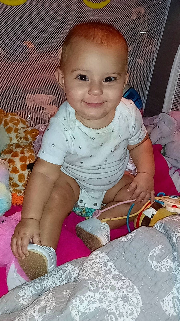 Ava joined the competition — help win amazing prizes! baby, baby_toddler_clothing, cheek, child, comfort, event, fun, happy, iris, joy, linens, pattern, person, pink, play, portrait_photography, sitting, skin, sleeve, smile