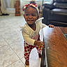 Emeri is registered to the contest to win money with this photo: architecture, baby, babylaughing, building, face, furniture, happy, hardwood, head, indoors, livingroom, person, photography, portrait, room, sitting, smile, standing, table, wood