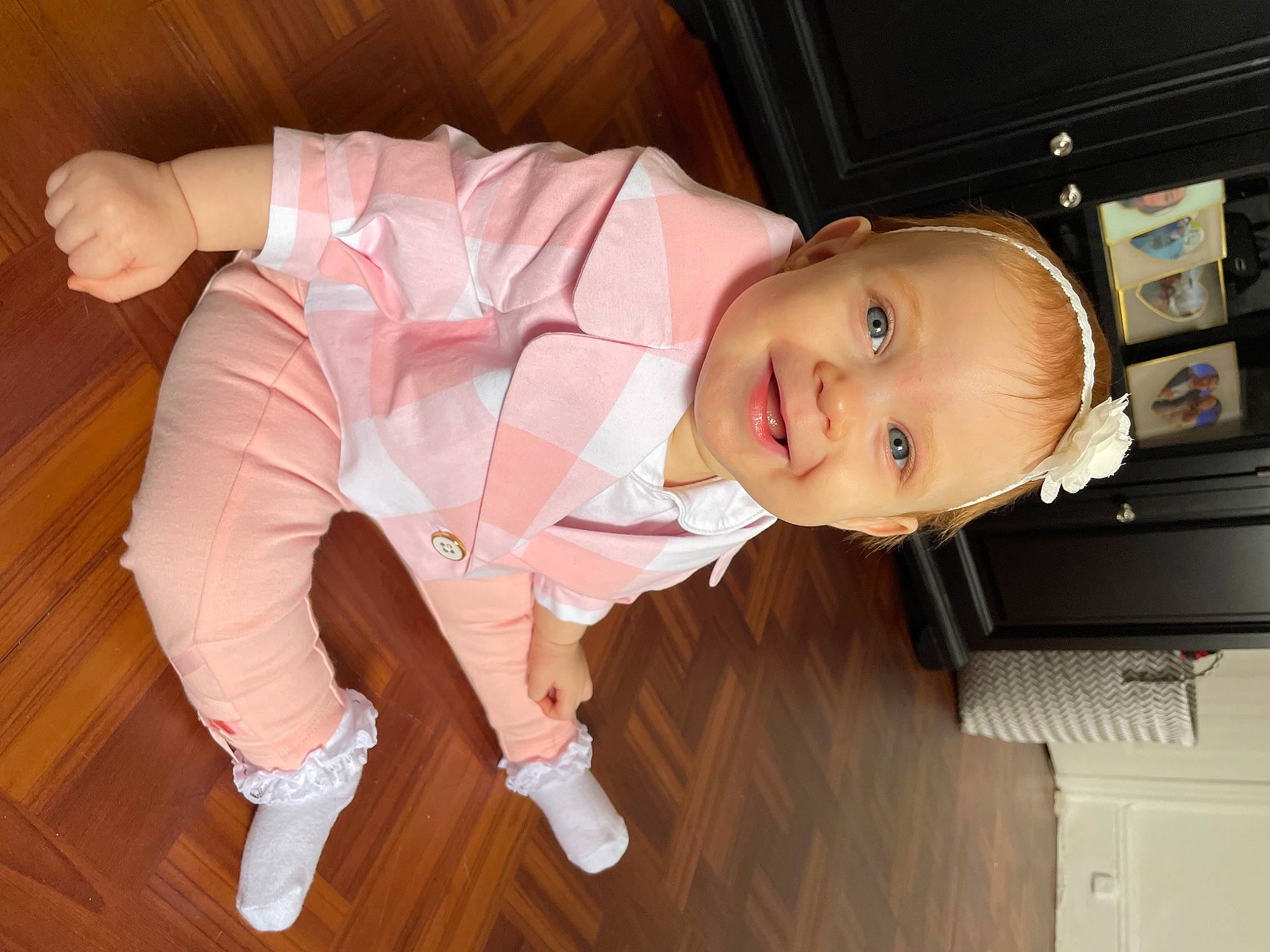 Arabella is registered to the contest to win money with this photo: baby, baby_toddler_clothing, cabinetry, child, comfort, drawer, flooring, fun, hardwood, joy, person, room, sitting, skin, sleeve, smile, thumb, toddler, varnish, wood