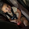 Amir joined the competition — help win amazing prizes! child, toddler, car_seat, vehicle, passenger, seatbelt, buckled, portrait, indoors, travel, toy, red_toy, curly_hair, smiling, face, sitting, casual_clothing, automobile, safe, photograph