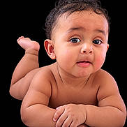 Javonta Jr is registered to the contest to win money with this photo: arms, baby, black_background, child, closeup, curly_hair, cute, expression, eyes, face, hands, infant, legs, lying_down, naked, portrait, skin, soft_skin, studio, toes