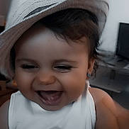 Souad participe au concours pour gagner de l'argent avec cette photo : baby, child, clothing, cute, earrings, expression, face, hair, hand, happy, hat, indoor, laughing, person, portrait, room, skin, smiling, toddler, white_shirt