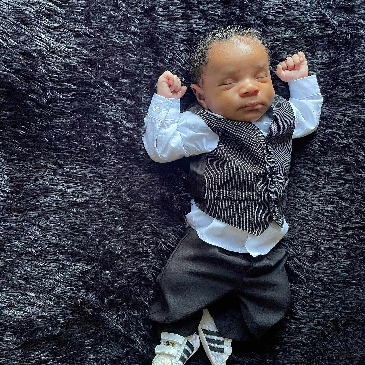 Chigozie joined the competition — help win amazing prizes! accessories, baby, bodypart, clothing, face, finger, footwear, formalwear, hand, head, pants, person, photography, portrait, shirt, shoe, sitting, sneaker, suit, tie