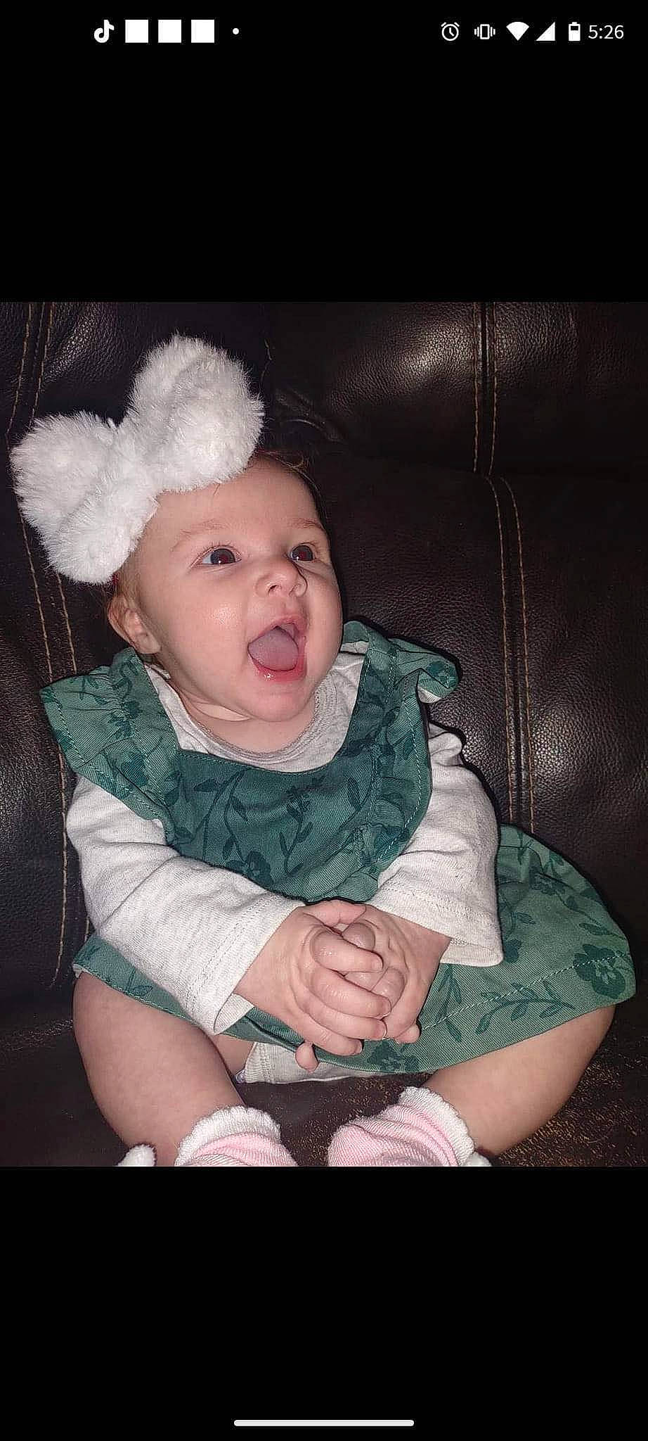 Aubrie is registered to the contest to win money with this photo: baby, baby_toddler_clothing, cheek, child, comfort, dress, ear, eye, eyelash, fashion_accessory, flash_photography, fur, hand, happy, headwear, iris, person, sitting, skin, sleeve