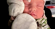 Kamylle is registered to the contest to win money with this photo: newborn, baby, sleeping, hat, mittens, pajamas, floral, soft, cozy, peaceful, infant, child, portrait, cute, hands, clothing, pink, white, closeup, indoors
