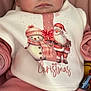 Charlotte is registered to the contest to win money with this photo: baby, infant, face, eyes, pink_clothing, bib, christmas, snowman, santa_claus, holiday, cute, soft_toys, cushion, indoors, child, portrait, closeup, happy, winter, festive