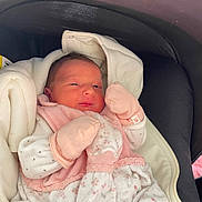Valentina participe au concours pour gagner de l'argent avec cette photo : newborn, baby, infant, mittens, blanket, carrier, pink, white, floral, clothing, cozy, sleepy, cute, small, face, head, resting, indoors, soft, wrapped