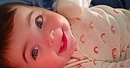 Adalynn joined the competition — help win amazing prizes! baby, smiling, bottle, milk, pillow, onesie, rainbow_pattern, bed, blanket, child, face, happy, indoor, person, infant, cute, lying_down, wall, blue_background, pink_pillow