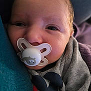 Ilyan participe au concours pour gagner de l'argent avec cette photo : baby, blanket, child, closeup, clothing, comfort, cute, face, head, indoors, infant, newborn, pacifier, person, portrait, resting, sleepy, soft, warm, young