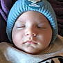 baby, sleeping, hat, knit_hat, monkey_patch, purple_blanket, batman_logo, clothing, face, infant, closeup, soft_texture, peaceful, child, portrait, headwear, cute, warm, resting, indoors