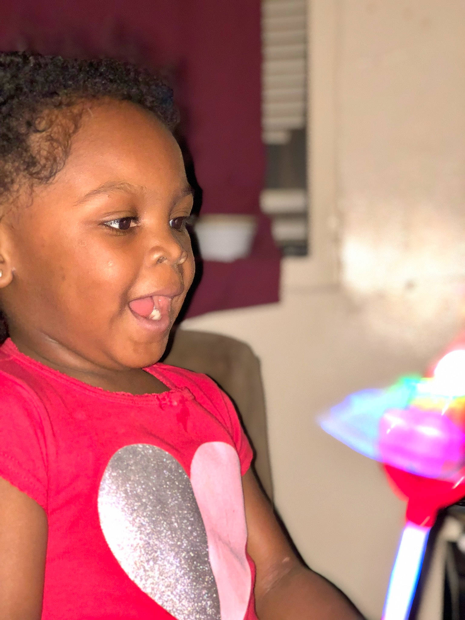 Natalya is registered to the contest to win money with this photo: black_hair, child, cornrows, hair, hairstyle, joy, neck, person, pink, smile, toddler