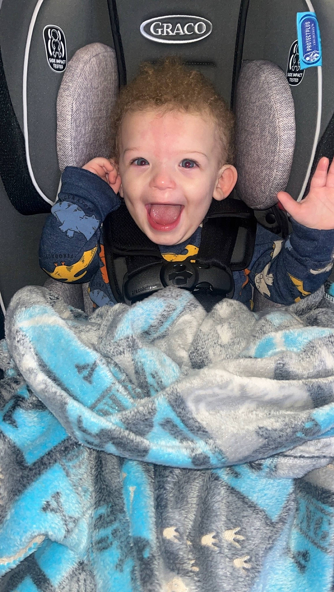 Jayceon is registered to the contest to win money with this photo: auto_part, baby_products, blue, car_seat, car_seat_cover, child, comfort, cool, electric_blue, family_car, fun, happy, head, luxury_vehicle, motor_vehicle, pattern, person, sitting, smile, toddler