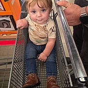 Asher joined the competition — help win amazing prizes! toddler, child, shopping_cart, boots, jeans, shirt, stain, hand, adult, store, floor, metal, retail, shopping, cute, baby, person, portrait, indoor, casual
