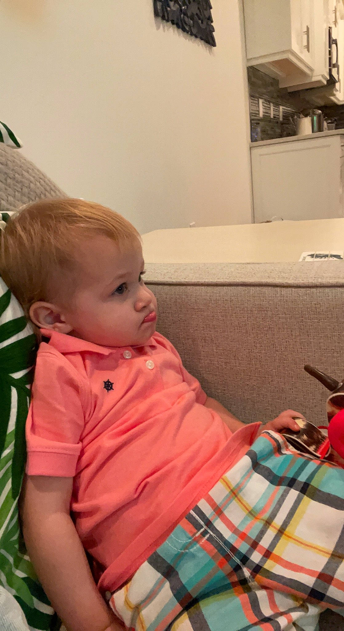 Nikolai is registered to the contest to win money with this photo: baby, baby_toddler_clothing, cheek, child, comfort, couch, flooring, fun, holiday, linens, pattern, person, plaid, play, room, sitting, skin, t_shirt, tartan, toddler