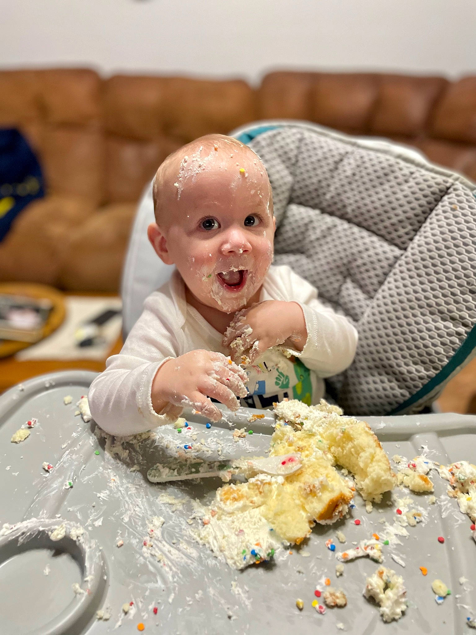 Nikolai is registered to the contest to win money with this photo: baby, chair, child, comfort_food, couch, cuisine, dessert, dish, event, food, happy, ingredient, person, plate, recipe, sitting, smile, surprise, sweetness, table