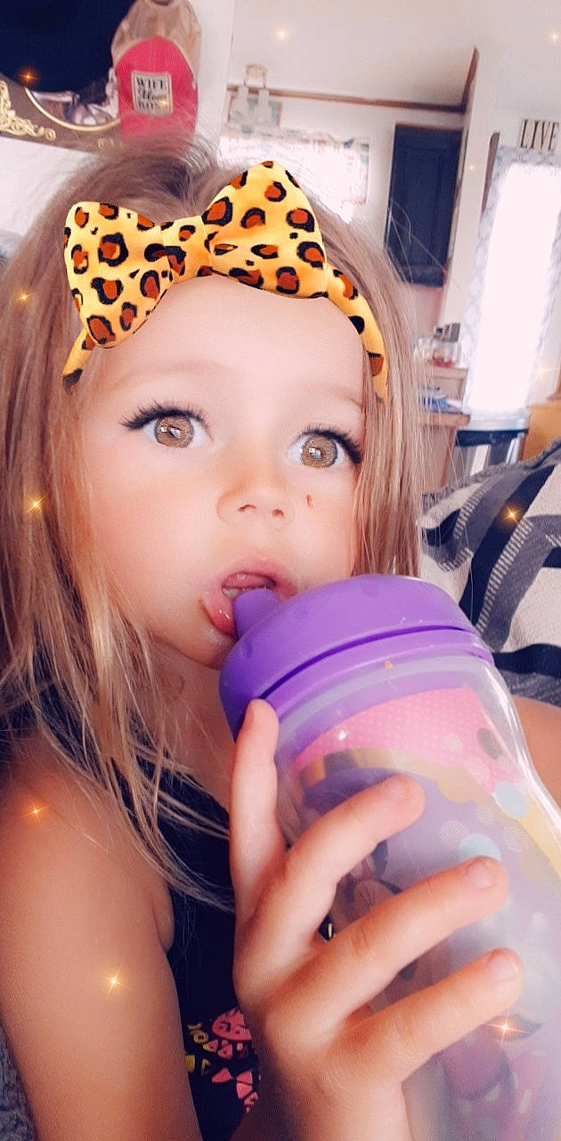Braelyn joined the competition — help win amazing prizes! blond, brown_hair, cap, child, cool, drinkware, electric_blue, eyebrow, eyelash, fun, happy, headband, headpiece, headwear, lip, nail, person, pink, plastic_bottle, purple
