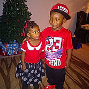 Devon is registered to the contest to win money with this photo: boy, child, children, christmas, christmas_tree, family, girl, hat, holiday, indoors, living_room, polka_dots, portrait, presents, red_clothing, skirt, smiling, standing, t_shirt, toddler