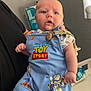 Jaxon joined the competition — help win amazing prizes! baby, child, infant, toy_story, overalls, clothing, person, arm, tattoo, indoor, window, curious, cute, holding, blue, cartoon_characters, light, face, skin, room