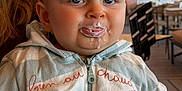 Raphaël participe au concours pour gagner de l'argent avec cette photo : baby, milk, milk_mustache, tongue, hoodie, zipper, hand, tattoo, pacifier, indoor, cafe, table, chair, light, person, child, cute, blue_eyes, clothing, holding