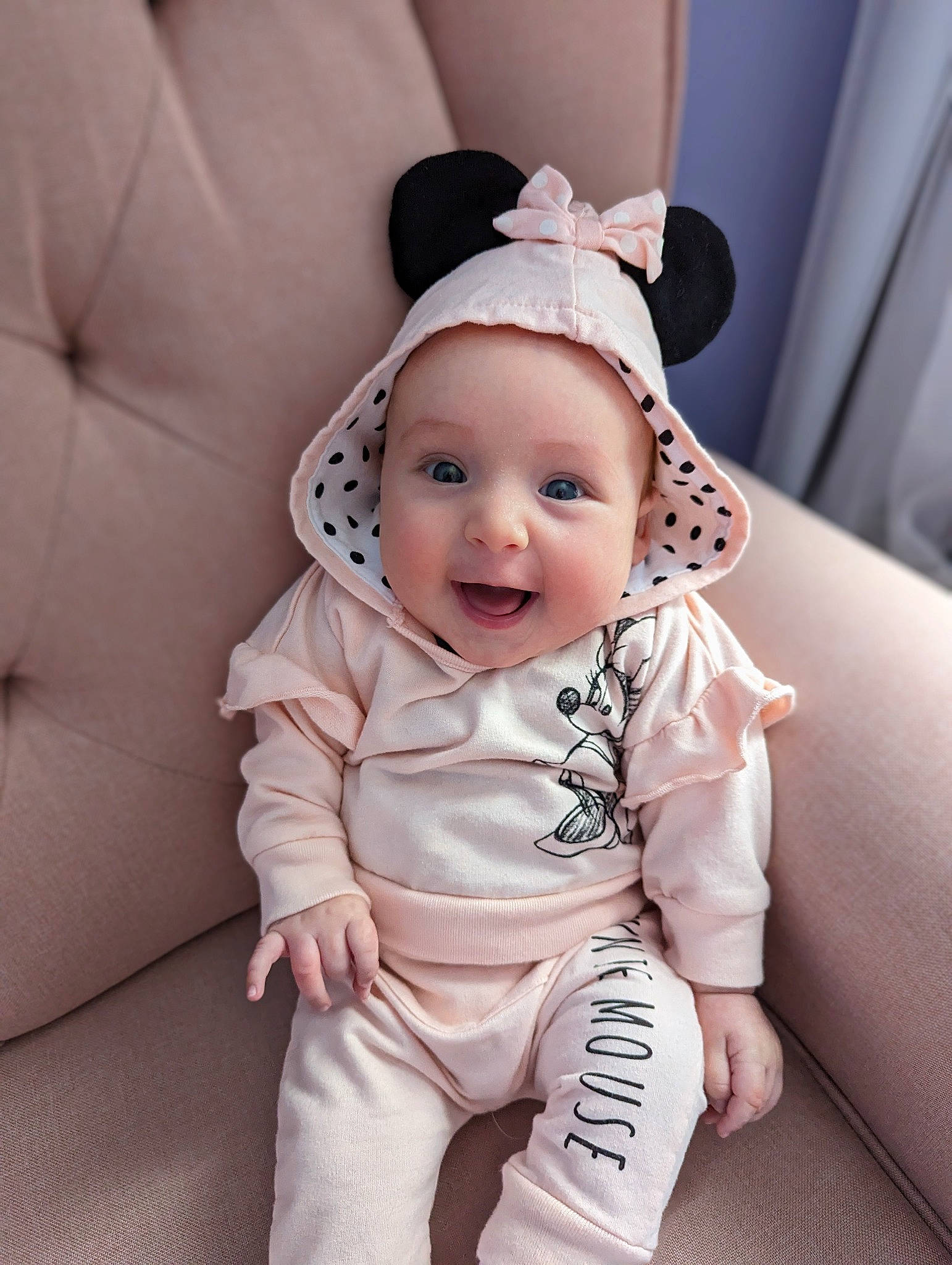 Evie is registered to the contest to win money with this photo: baby, baby_toddler_clothing, cap, child, comfort, costume_hat, couch, eye, fashion_accessory, fun, happy, headwear, linens, pattern, person, room, sitting, skin, sleeve, smile