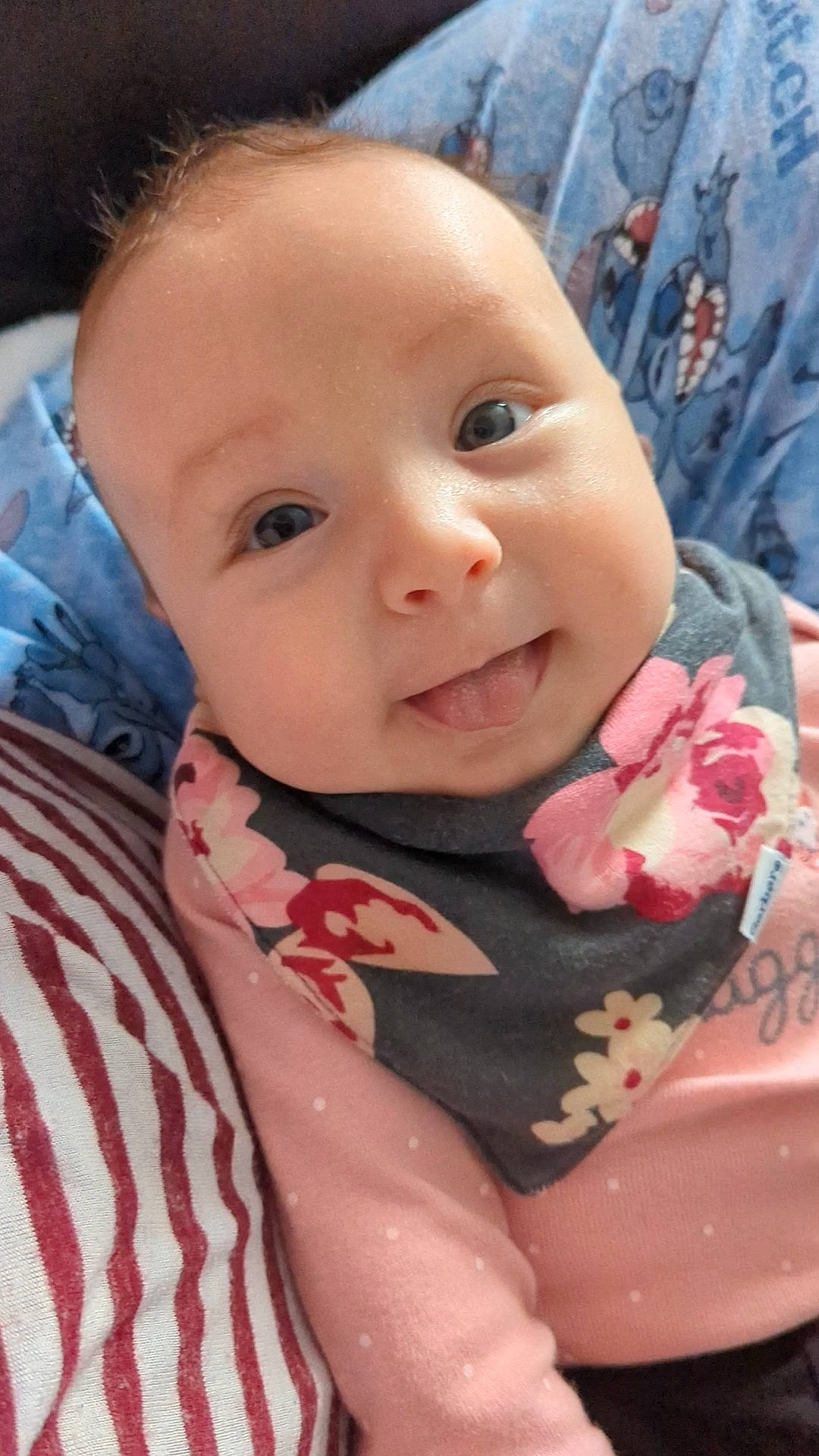 Evie is registered to the contest to win money with this photo: baby, baby_toddler_clothing, cheek, child, chin, eyelash, happy, iris, lip, mouth, nose, pattern, person, petal, pink, rose, skin, sleeve, smile, textile