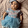 Ridgley joined the competition — help win amazing prizes! baby, child, infant, girl, headband, blue_tutu, floral_top, blanket, texture, soft, cute, portrait, lying_down, clothing, fashion, adorable, young, skin, face, expression