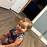 Raven joined the competition — help win amazing prizes! appliance, brown_hair, candid, child, doorway, dress, eyes, face, floor, floral_outfit, happy, home, indoors, photography, playful, portrait, sitting, smiling, toddler, wood_floor