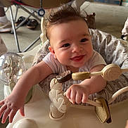 Eastyn joined the competition — help win amazing prizes! baby, smiling, infant, activity_center, toy, indoor, person, child, happy, reaching, seat, furniture, adult, legs, clothing, floor, hand, face, expression, hair