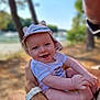 Noé a rejoint le concours — aidez-le/la à gagner de superbes lots ! baby, smiling, hat, outdoor, person, child, face, arms, happy, nature, trees, water, sunlight, holding, closeup, summer, casual, watch, skin, background
