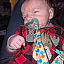 Kristopher is registered to the contest to win money with this photo: baby, infant, pacifier, clothing, red, black, checkered, plush, face, hand, person, indoors, fabric, sleepy, cute, pacifier_clip, moose_design, child, newborn, portrait