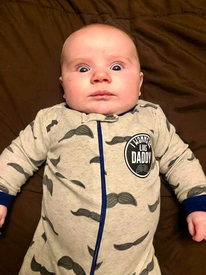 Bo is registered to the contest to win money with this photo: baby, baby_toddler_clothing, cheek, child, collar, comfort, cool, flash_photography, flooring, happy, head, long_sleeved_t_shirt, nose, outerwear, pattern, person, sitting, skin, sleeve, t_shirt