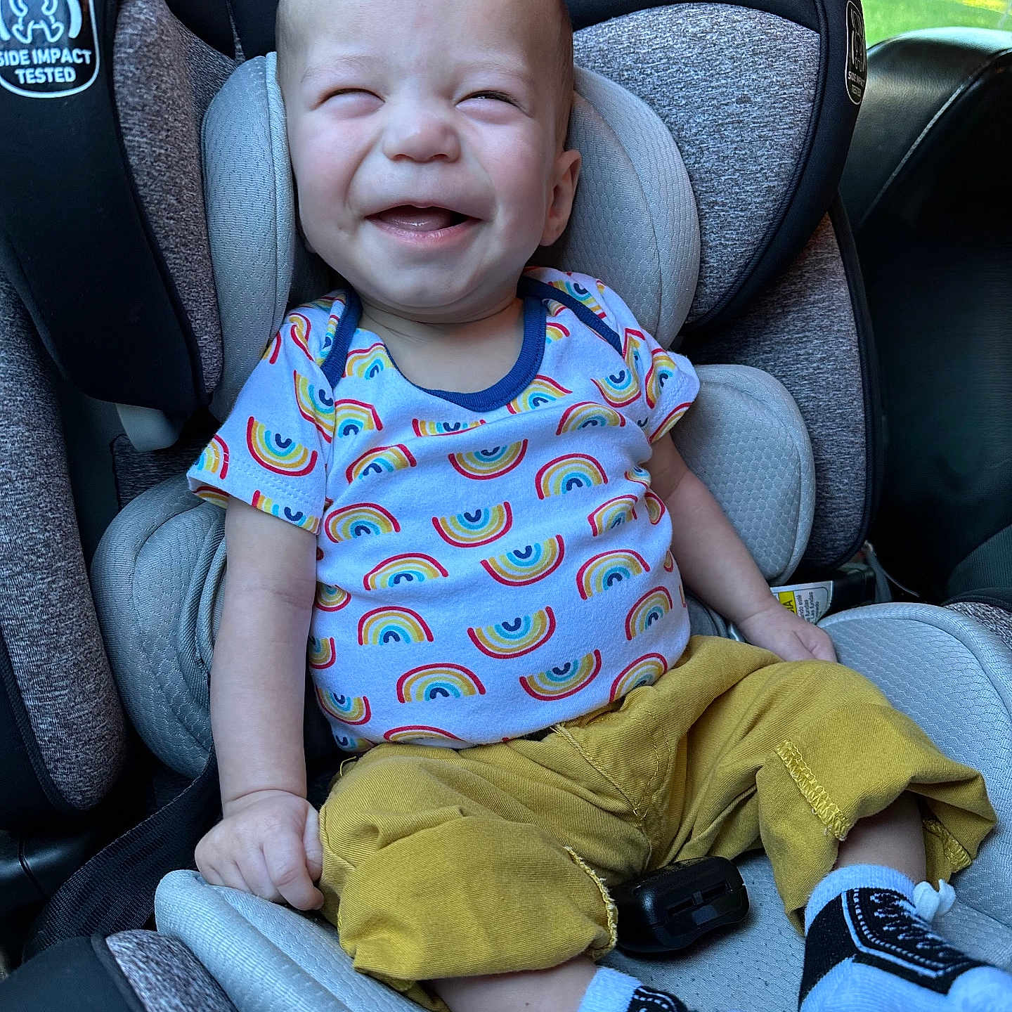 Lincoln is registered to the contest to win money with this photo: baby, babylaughing, clothing, face, footwear, happy, head, homedecor, hosiery, laughing, pants, person, photography, portrait, shoe, sitting, sneaker, sock, t_shirt, transportation