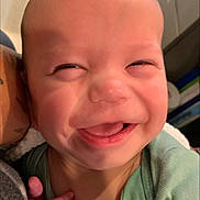 Lincoln is registered to the contest to win money with this photo: accessories, baby, babylaughing, bodypart, face, finger, furniture, hand, happy, head, jewelry, laughing, mouth, necklace, newborn, person, photography, portrait, smile, teeth