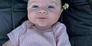 Leylanie joined the competition — help win amazing prizes! baby, infant, child, pink_clothing, ribbed_shirt, blue_eyes, face, head, skin, outdoor, grass, black_mat, flower, lying_down, cute, portrait, young, person, smile, closeup