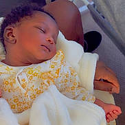 Osose joined the competition — help win amazing prizes! baby, sleeping, blanket, yellow_flower_pattern, infant, child, hand, lap, cozy, soft, indoor, person, cute, resting, peaceful, clothing, newborn, portrait, comfort, toddler