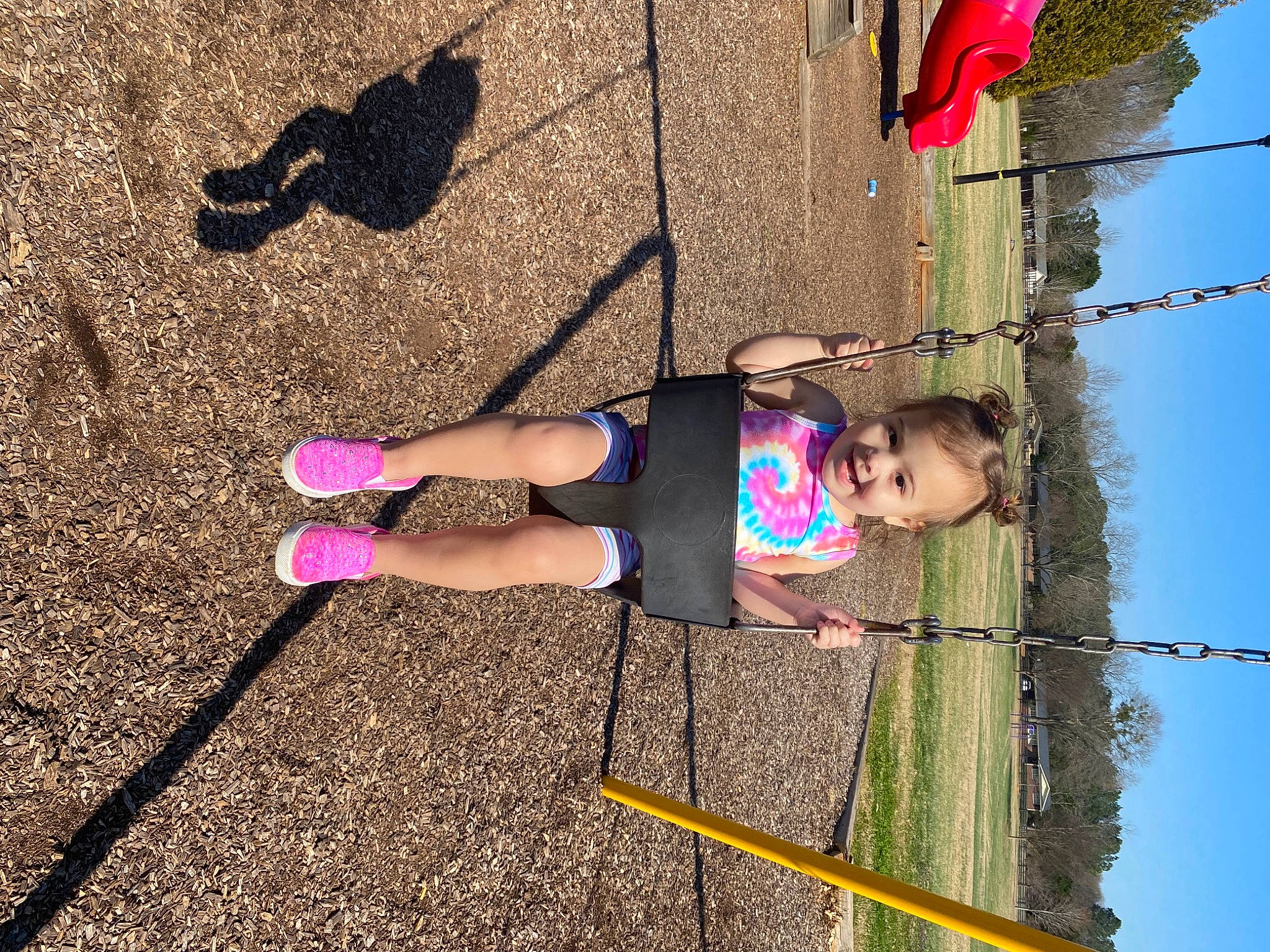 Kali is registered to the contest to win money with this photo: calf, child, electric_blue, fun, green, happy, human_leg, joy, leg, leisure, line, magenta, person, pink, recreation, red, sandal, sky, t_shirt, thigh