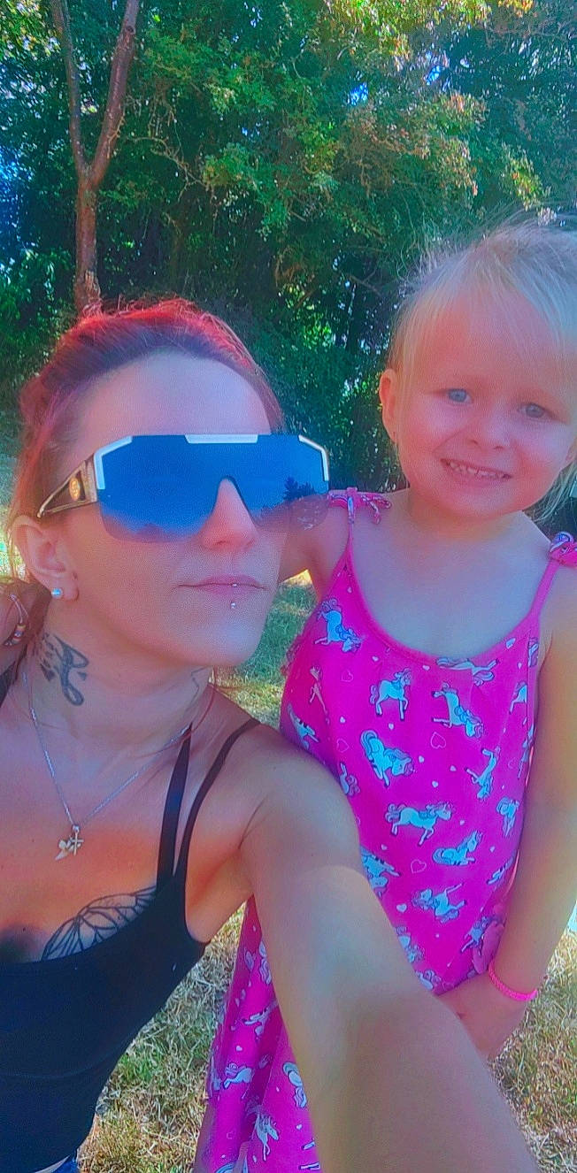 Judith participe au concours pour gagner de l'argent avec cette photo : cool, eyewear, facial_expression, fun, goggles, grass, hairstyle, happy, interaction, joy, leaf, leisure, magenta, morning, person, pink, skin, smile, sunlight, toddler